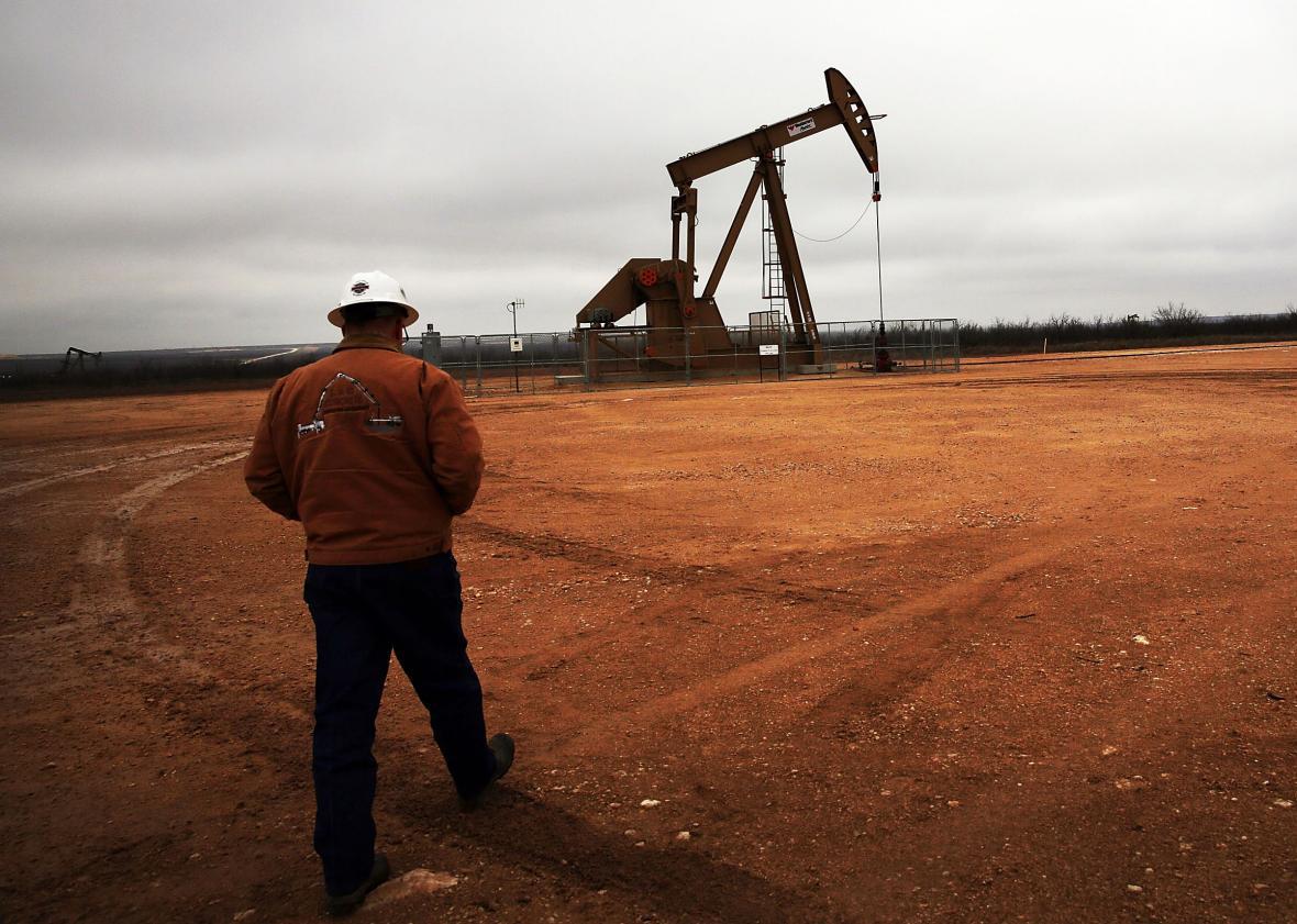 An oil well owned an operated by Apache Corporation in the Permian Basin are viewed on February 5, 2015 in Garden City, Texas. 