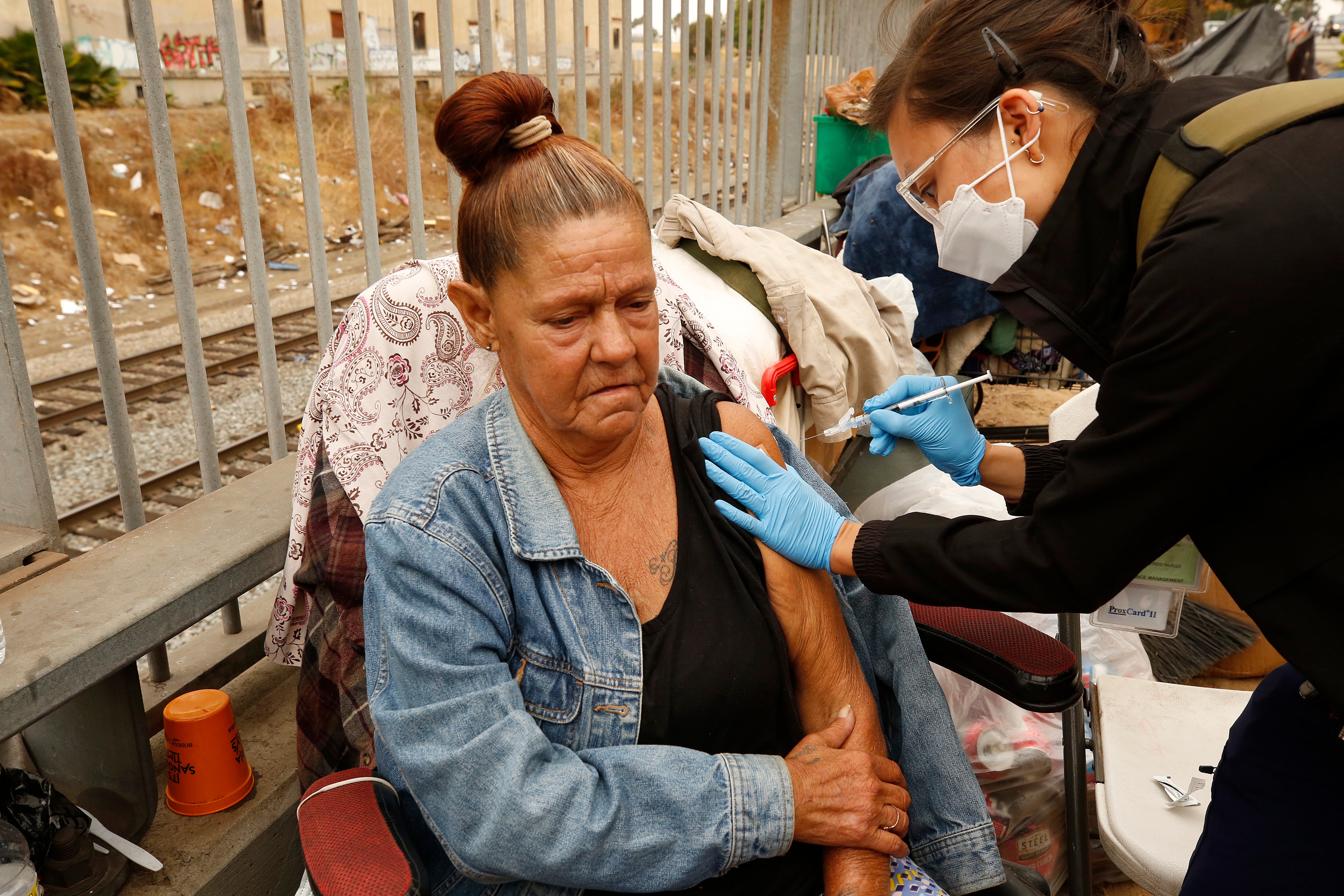 Denise Lerma receives a vaccine outdoors in LA.