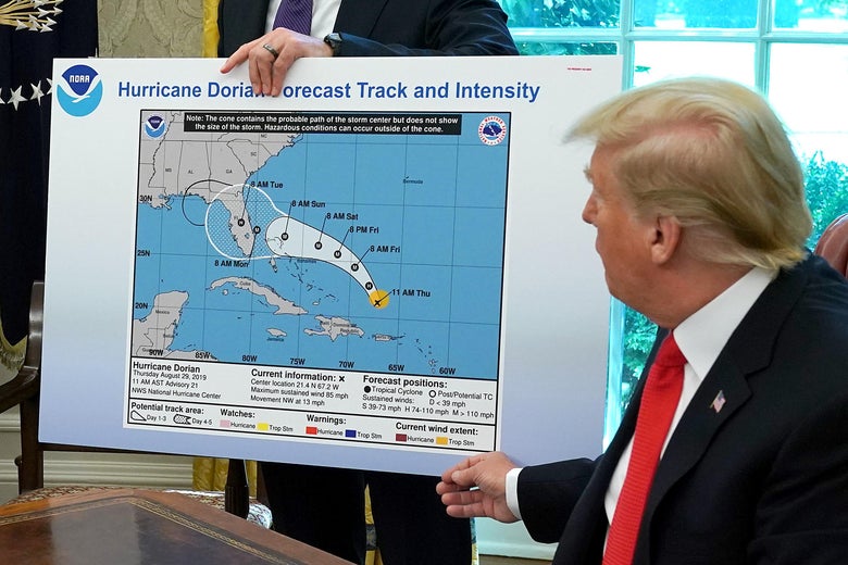 President Donald Trump references a map held by acting Homeland Security Secretary Kevin McAleenan while talking to reporters about Hurricane Dorian in the Oval Office at the White House September 4, 2019 in Washington, D.C.