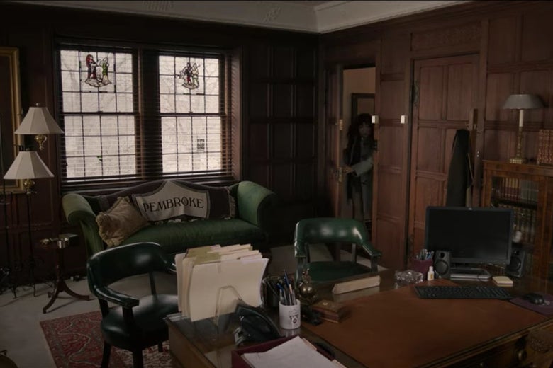 Green leather chairs in front of the desk in Dr. Kim's office.