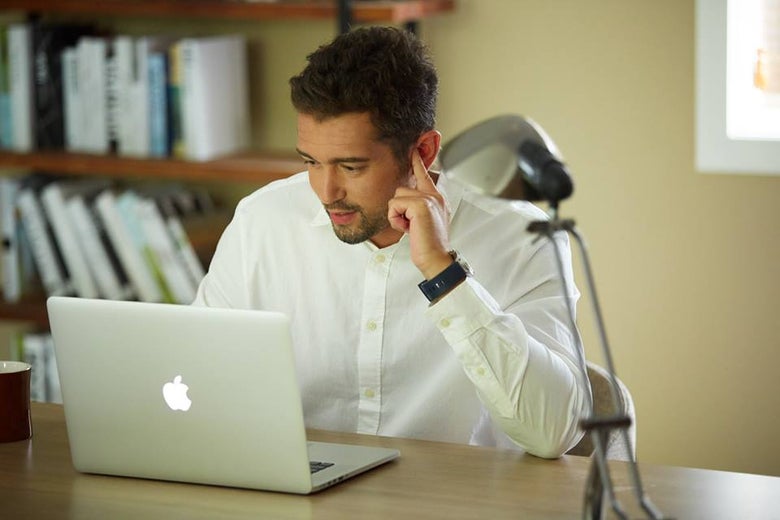 A man listening to his finger.