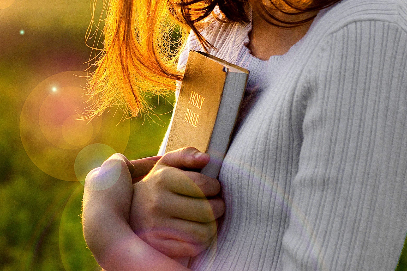 A woman clutching a Bible.