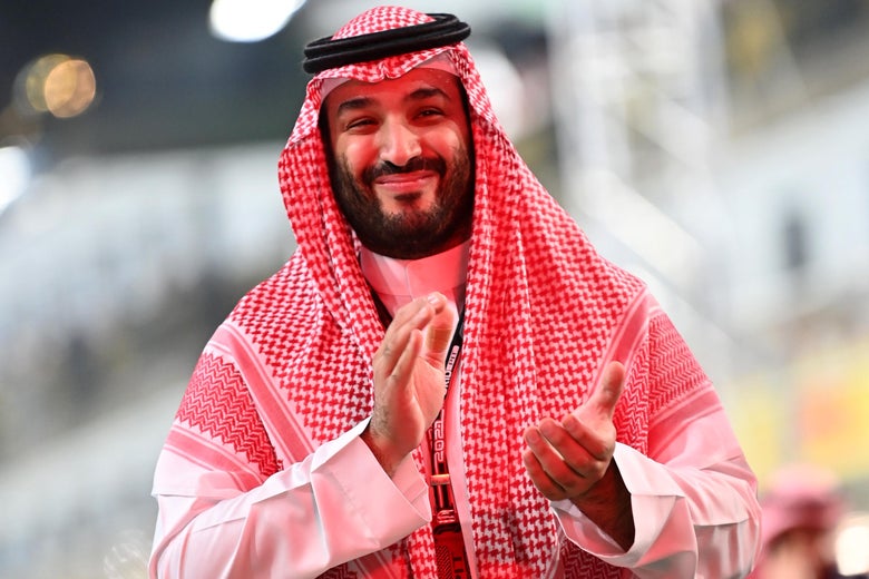 Mohammed bin Salman claps at an F1 race.