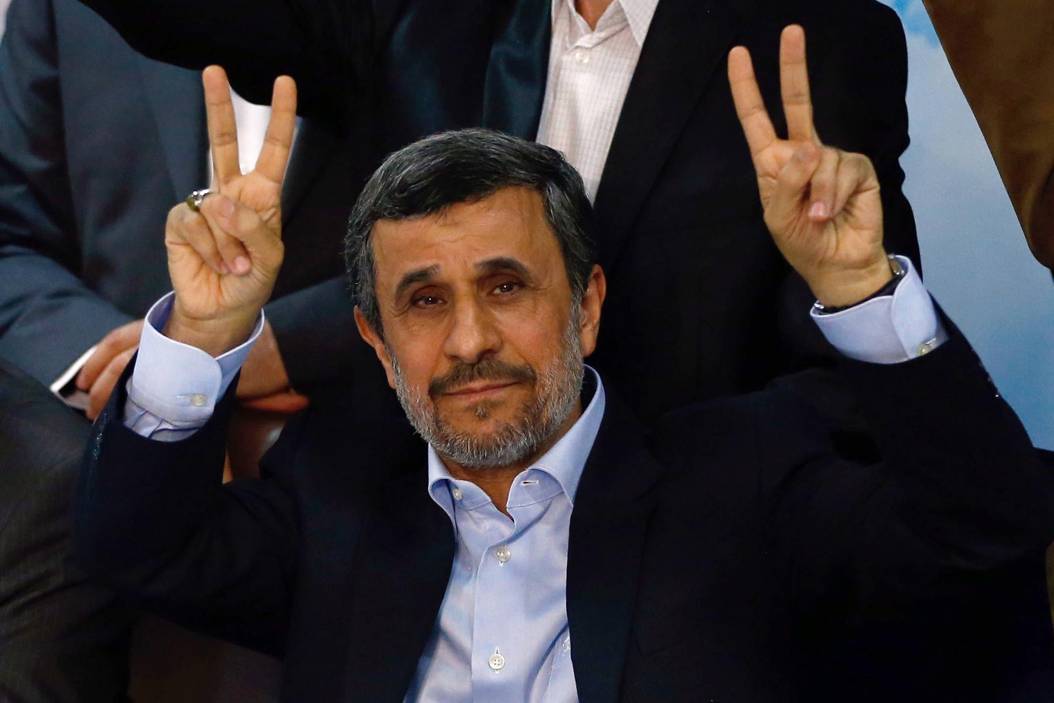 Former Iranian president Mahmoud Ahmadinejad (C) flashes the sign for victory at the Interior Ministry's election headquarters as candidates begin to sign up for the upcoming presidential elections in Tehran on April 12, 2017.Ahmadinejad had previously said he would not stand after being advised not to by supreme leader Ayatollah Ali Khamenei, saying he would instead support his former deputy Hamid Baghaie who also registered on Wednesday.
