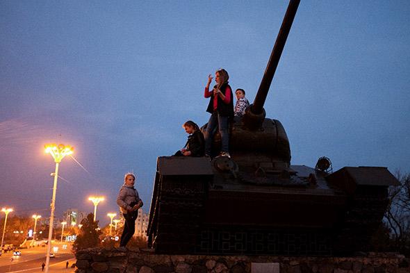 Children play on a tank, a monument to Transnistria's 1992 war of secession with Moldova in which over 1000 people were killed.
