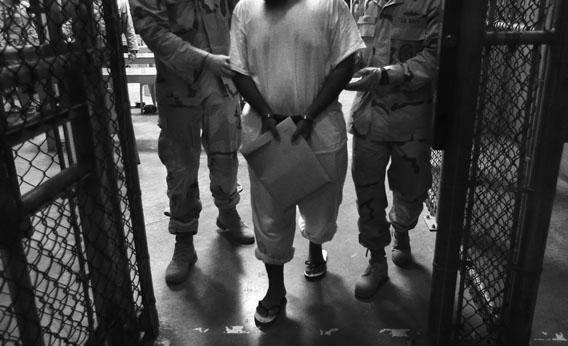 In this file photo, U.S. guards escort an unnamed detainee after a "life skills" class for prisoners at Guantánamo Bay in 2010.