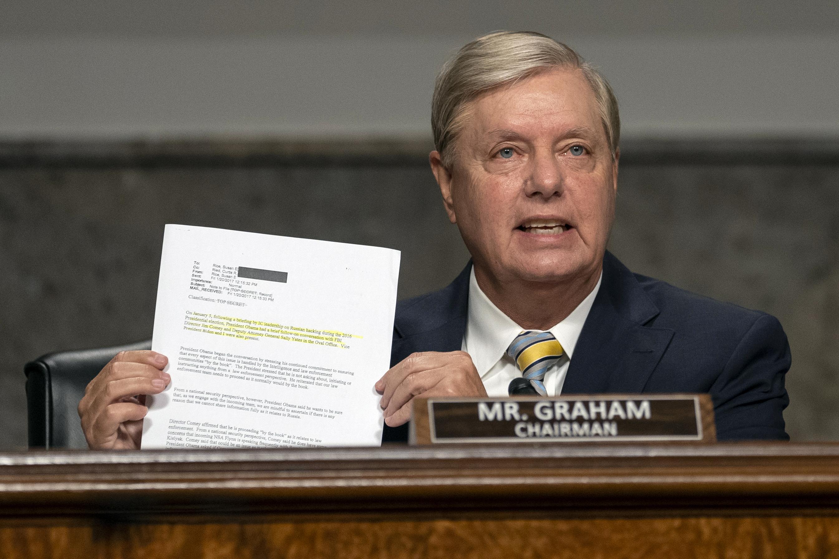 Lindsey Graham holds up a memo at a hearing.