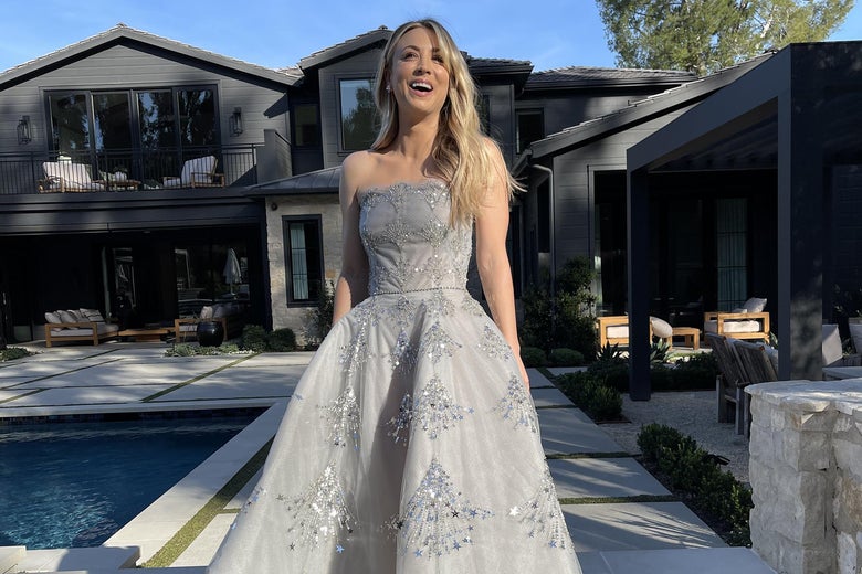 Kaley Cuoco stands by a pool in her Golden Globes gown.