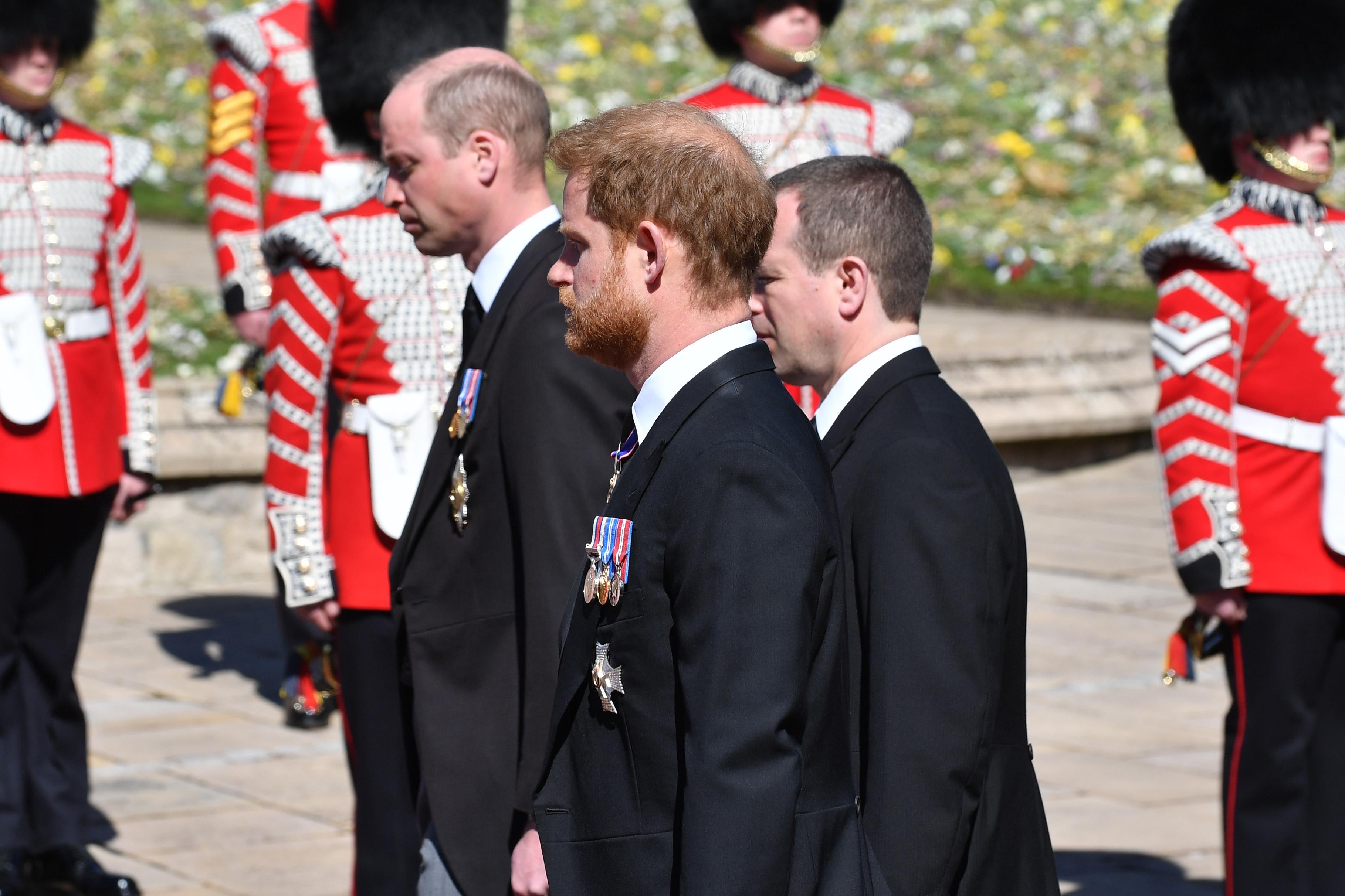 Prince William, Duke of Cambridge; Prince Harry, Duke of Sussex and Peter Phillips walk behind Prince Philip, Duke of Edinburgh's coffin in a procession during the funeral of Prince Philip, Duke of Edinburgh at Windsor Castle on April 17, 2021 in Windsor, United Kingdom. 