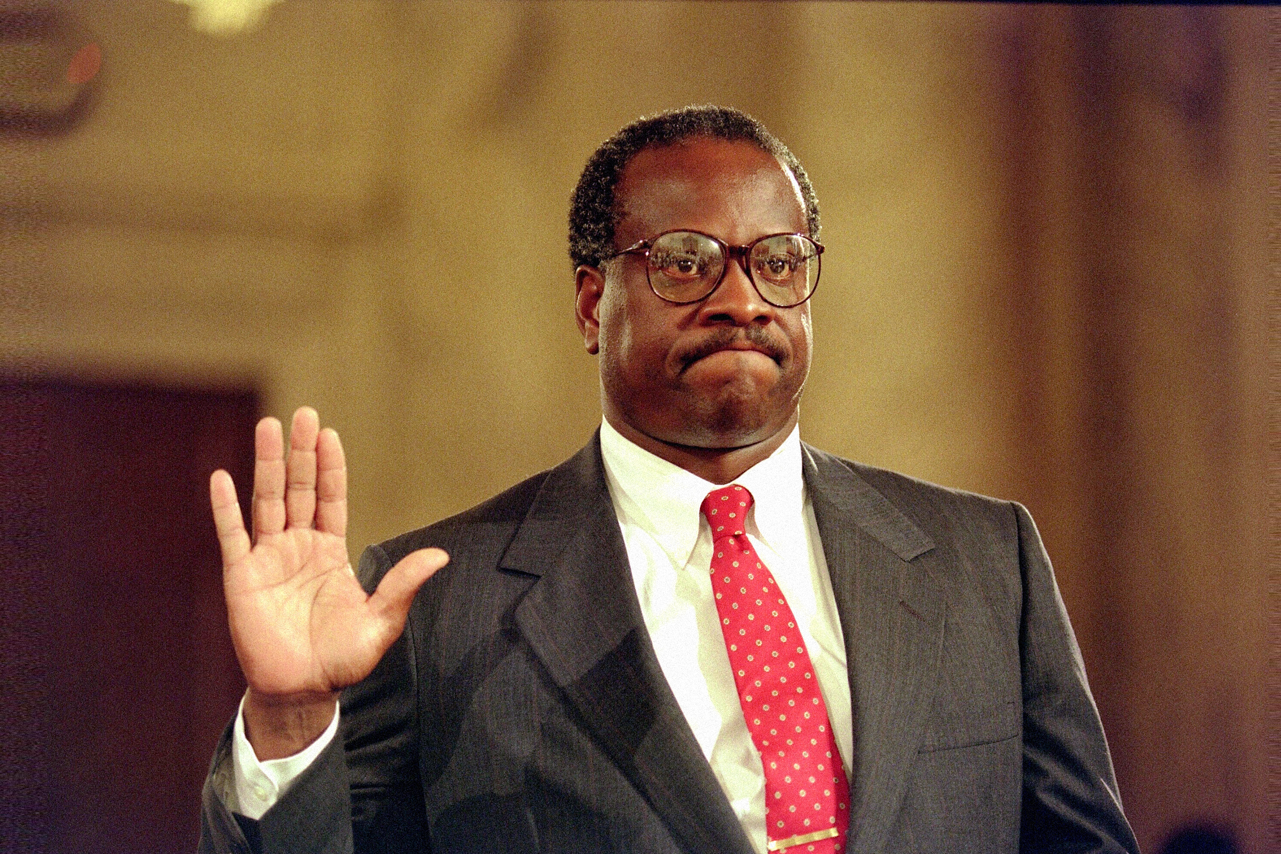 Supreme Court Justice Clarence Thomas holds up his right hand during his confirmation hearing in 1991. 