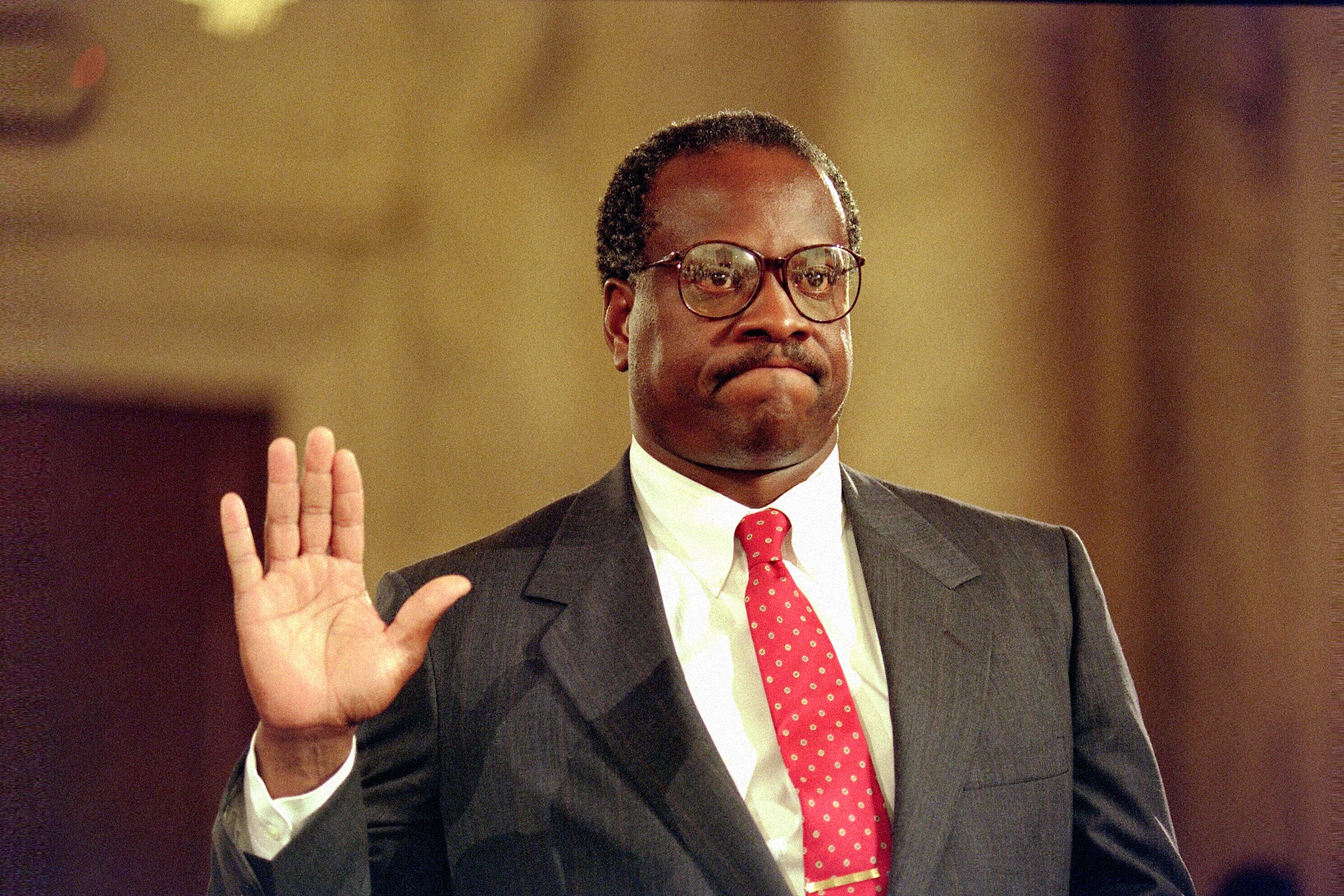 Supreme Court Justice Clarence Thomas holds up his right hand during his confirmation hearing in 1991.