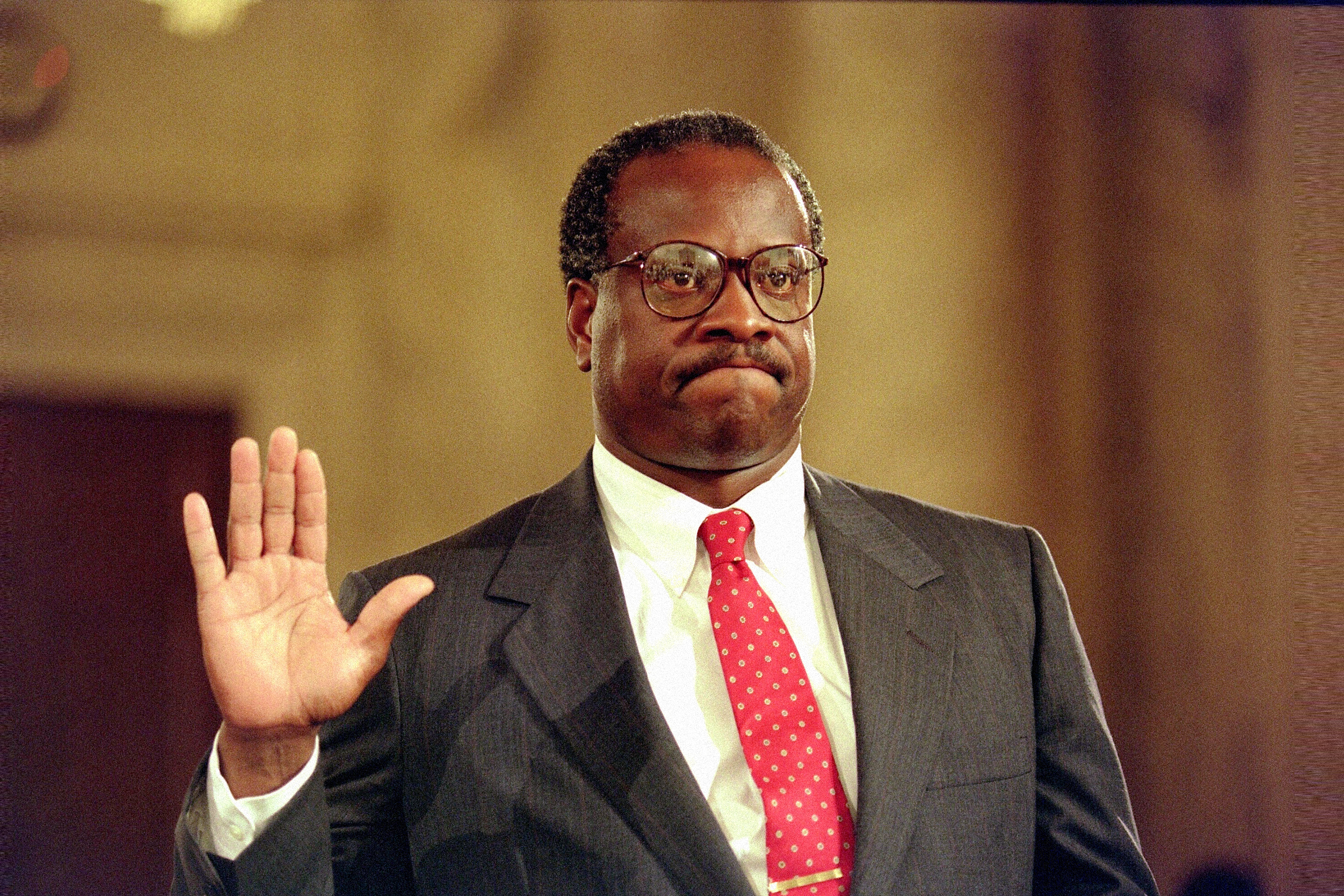 Supreme Court Justice Clarence Thomas holds up his right hand during his confirmation hearing in 1991. 