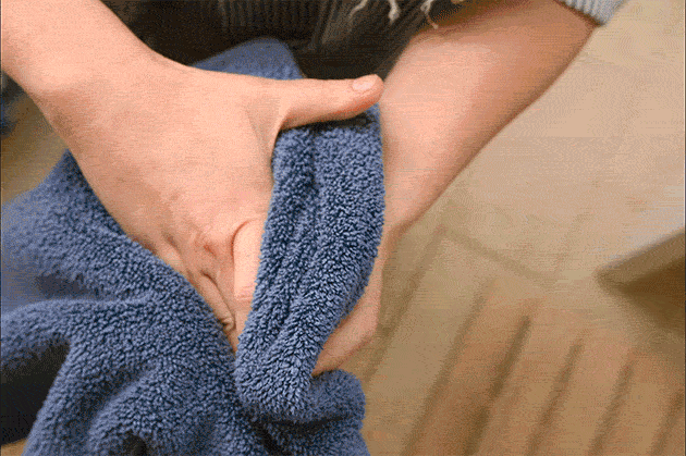 Hands twisting towels
