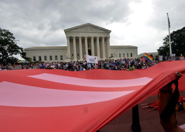 People wave a giant equality flag in celebration outside the Supreme Court in Washington, D.C. on June 26, 2015, after its historic decision on gay marriage.