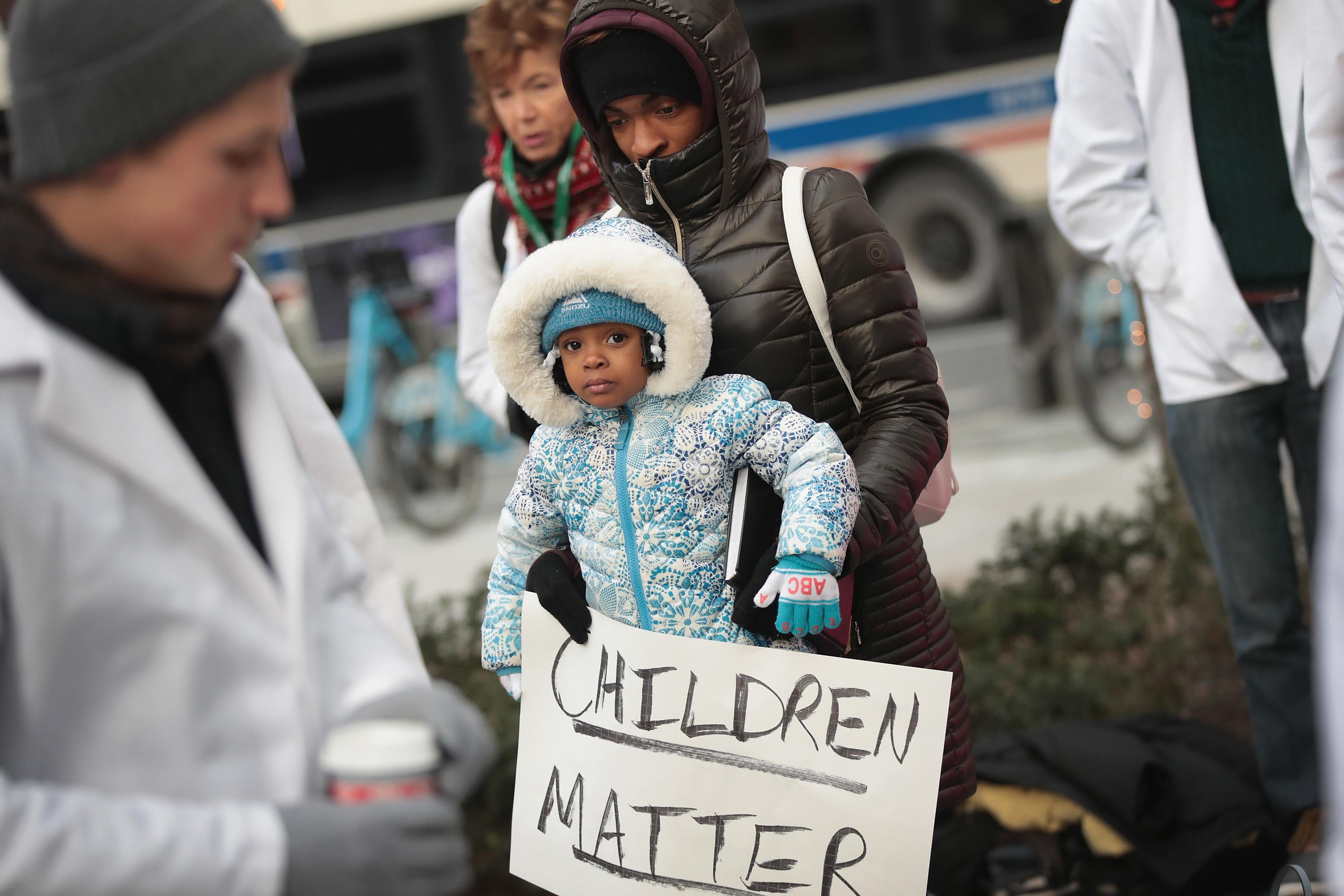 CHICAGO, IL - DECEMBER 14: Melanie Lockridge and her 2-year-old daughter Zariyah attend a rally hosted by University of Chicago medical students to call on Congress to reauthorize funding forthe Children's Health Insurance Program (CHIP) on December 14, 2017 in Chicago, Illinois. On September 30, congress let funding for CHIP expire, leaving states to carry the burden for medical expenses of the 9 million children enrolled in the program. Lockeridge's two daughters were enrolled in the program.  (Photo by Scott Olson/Getty Images)