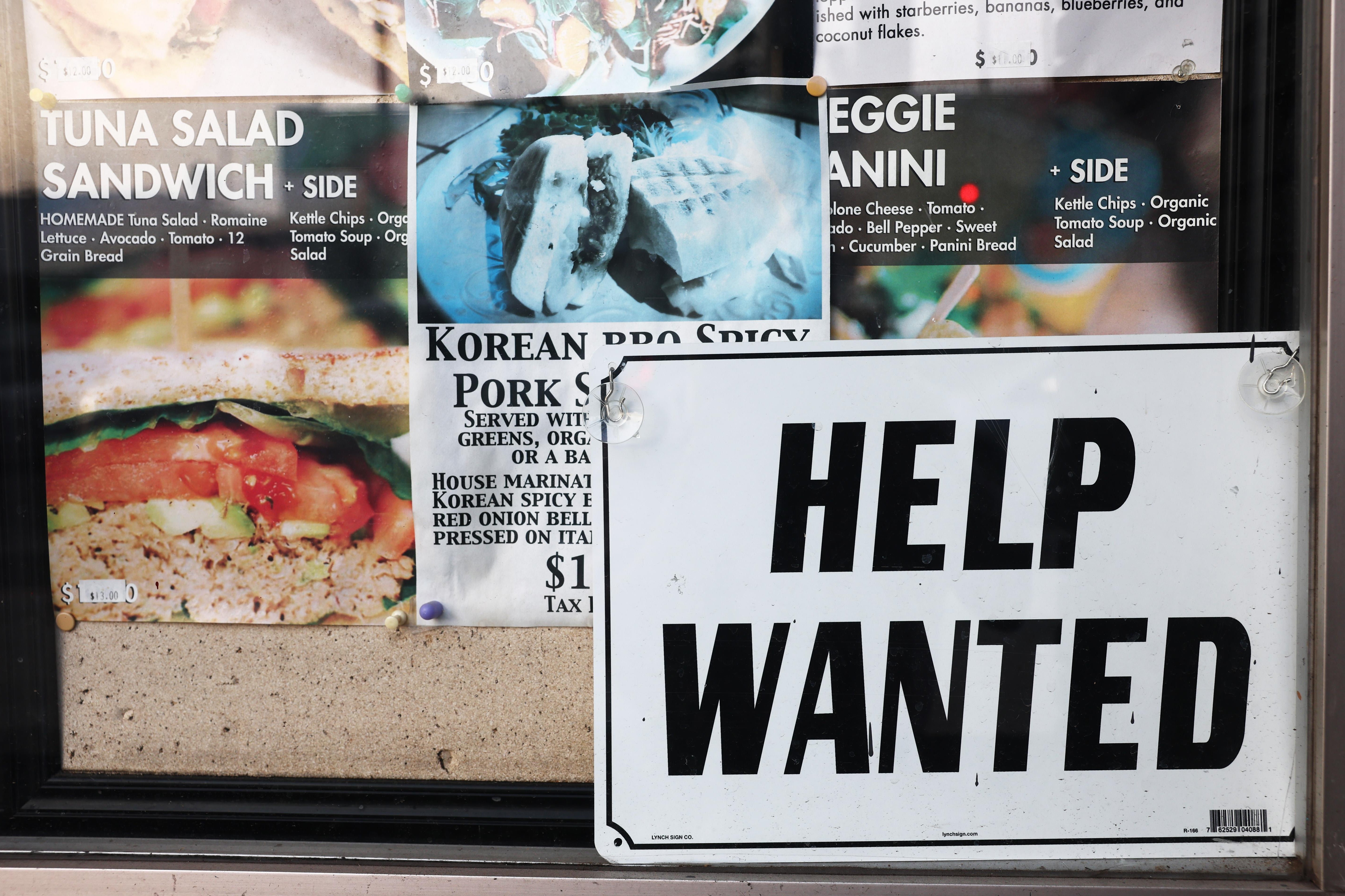 A Help Wanted sign is posted at a restaurant amid a still-robust labor market on February 2, 2023 in Los Angeles, California. Unemployment benefit applications have declined to the lowest level since April, 2022, with the U.S. Labor Department reporting that jobless claims fell slightly to 183,000 this week.  (Photo by Mario Tama/Getty Images)