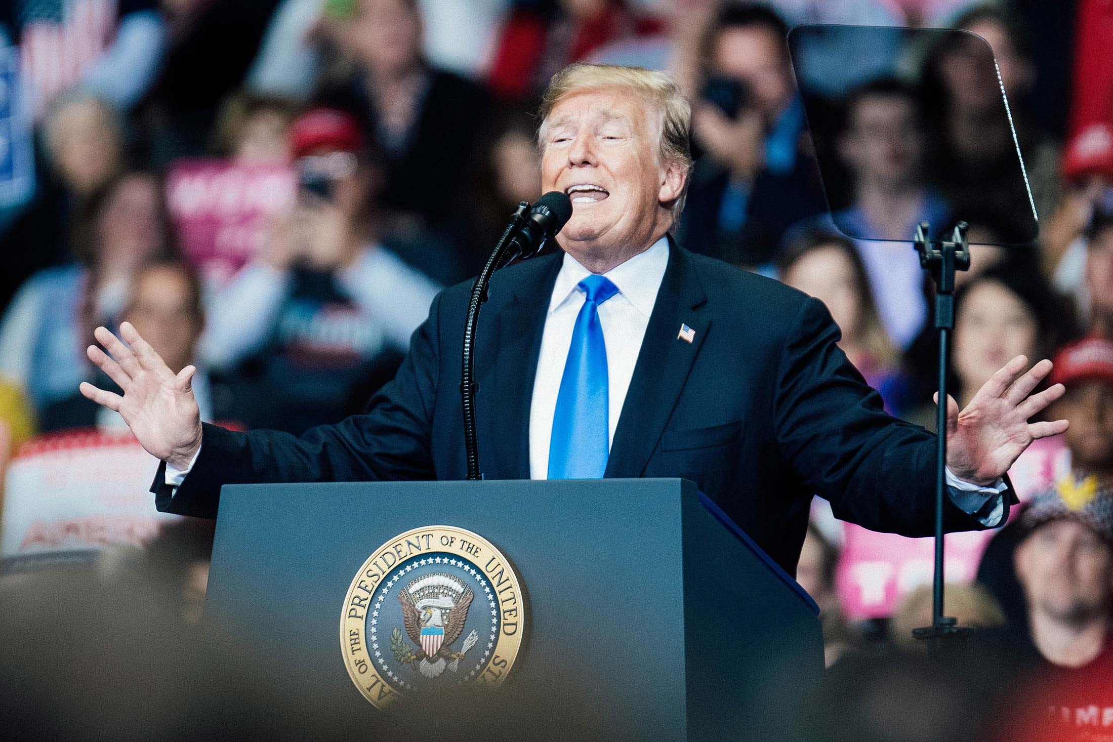 President Donald Trump at a podium at a rally.