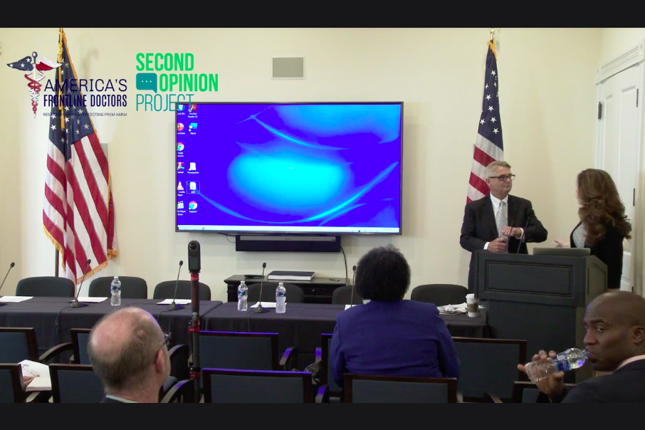 Ladapo is seen drinking from a water in a conference room in a still from a Facebook Live broadcast.