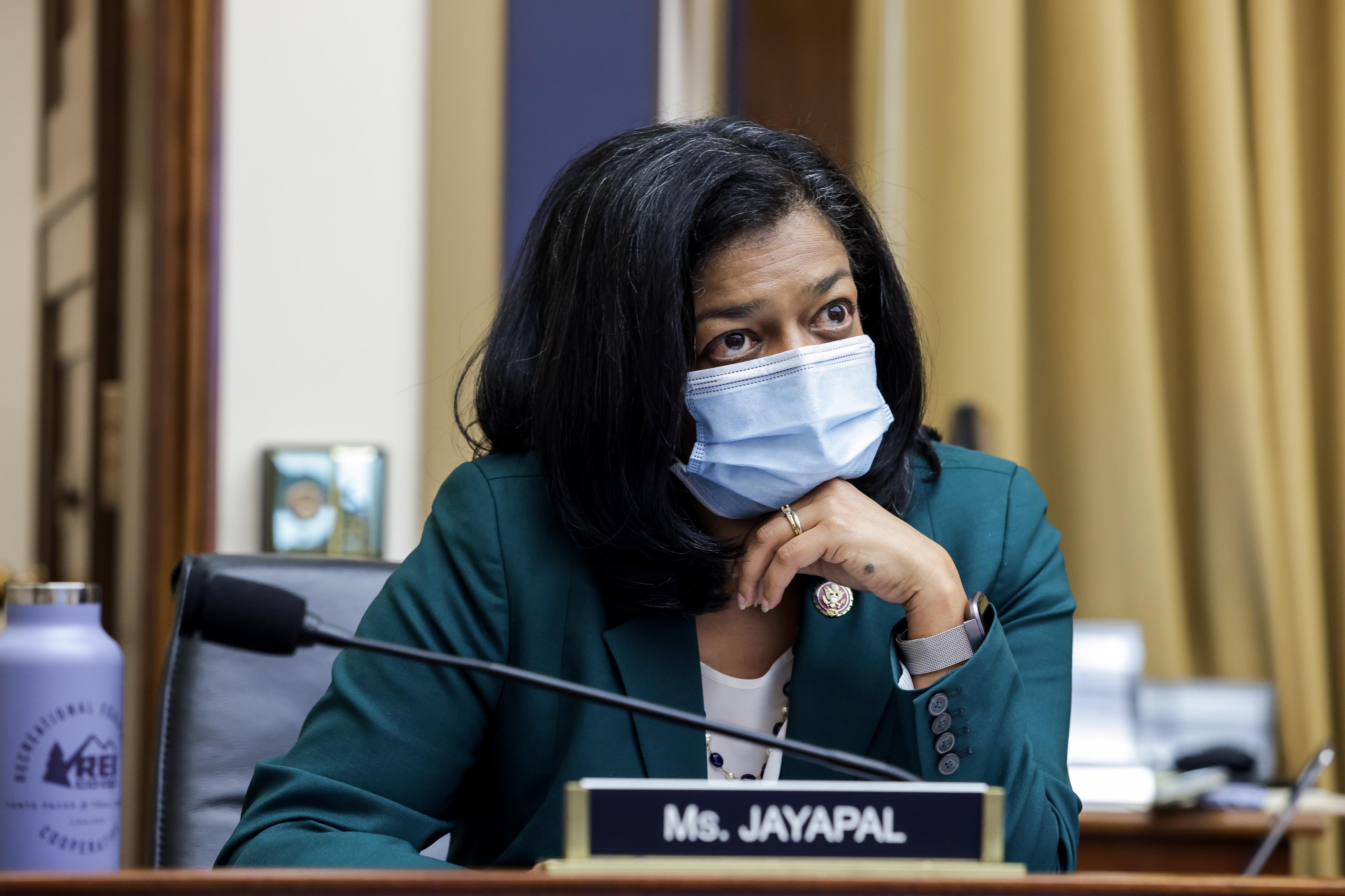 Jayapal wears a mask as she sits in a hearing room.