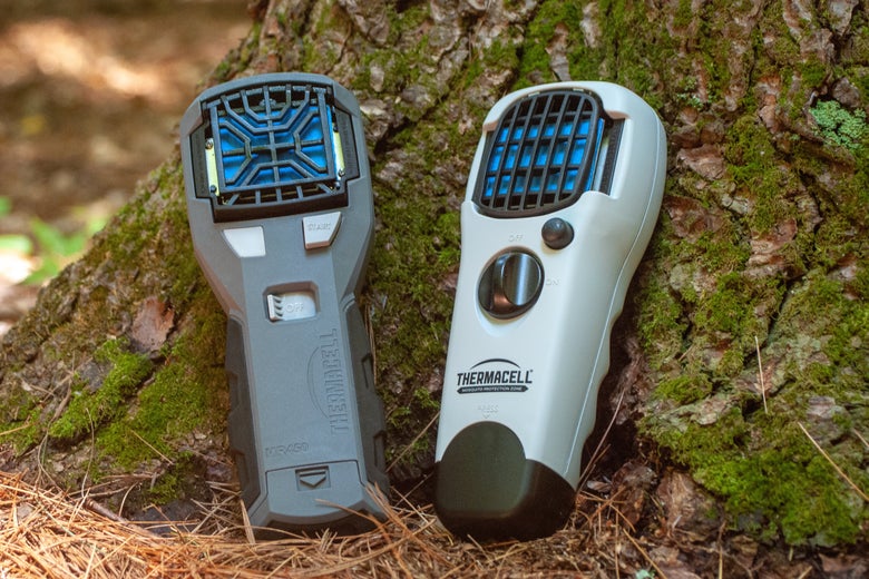 two Thermacell units resting against a tree trunk