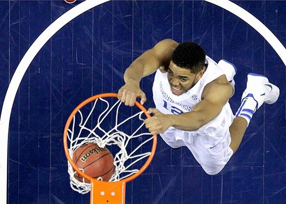 Kentucky Wildcat Karl-Anthony Towns dunks the ball against the Arkansas Razorbacks in the championship game of the SEC championship game in Nashville, Tennessee, on March 15, 2015.