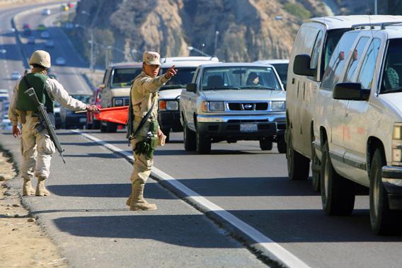 Soldiers of the Mexican Army stop vehicles as part of a security operation at a checkpoint in Tijuana, in the border state of Baja California, Mexico, 06 January 2007.