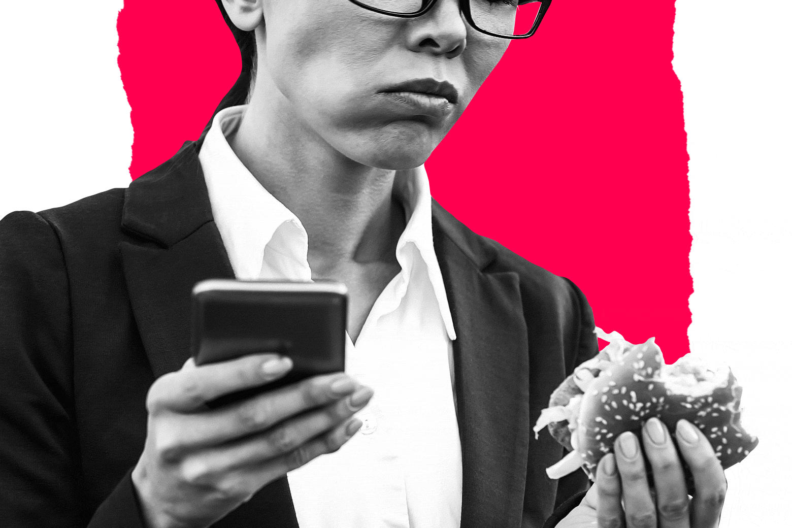 A woman looks between her phone in one hand and a burger in the other.