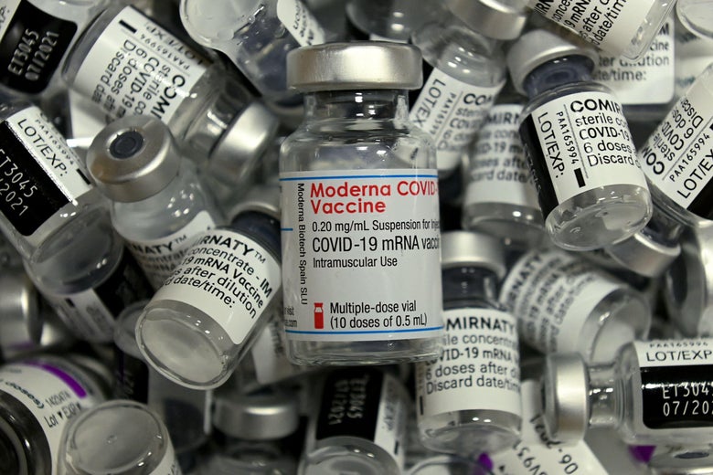 A pile of empty vials of Moderna, Pfizer, and AstraZeneca vaccines