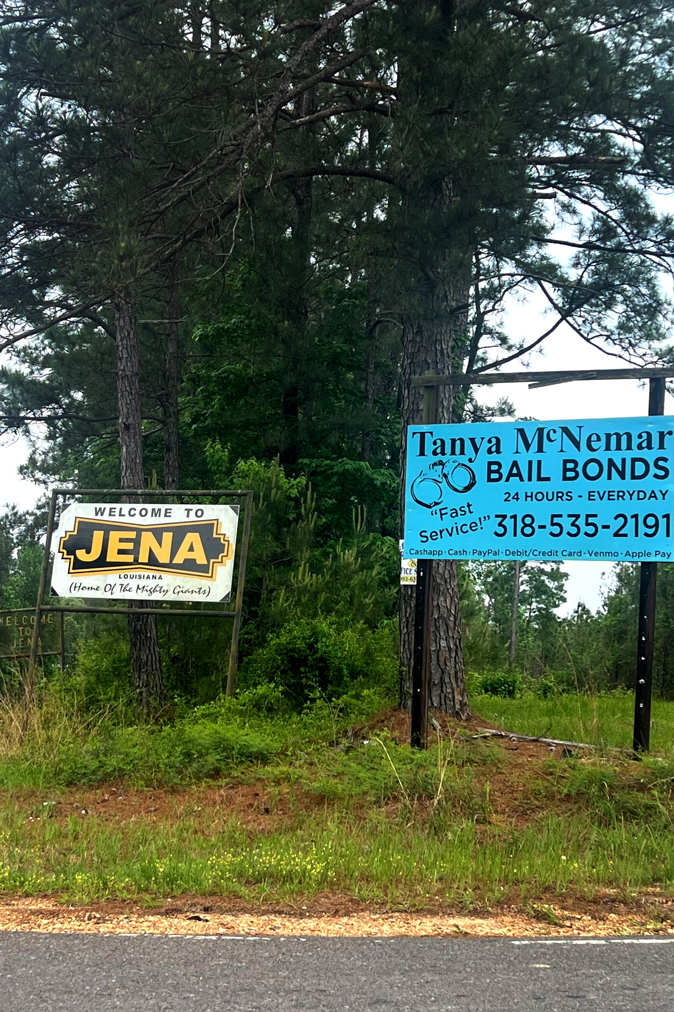  the welcome sign to Jena, and an ad for a bail bondsman.