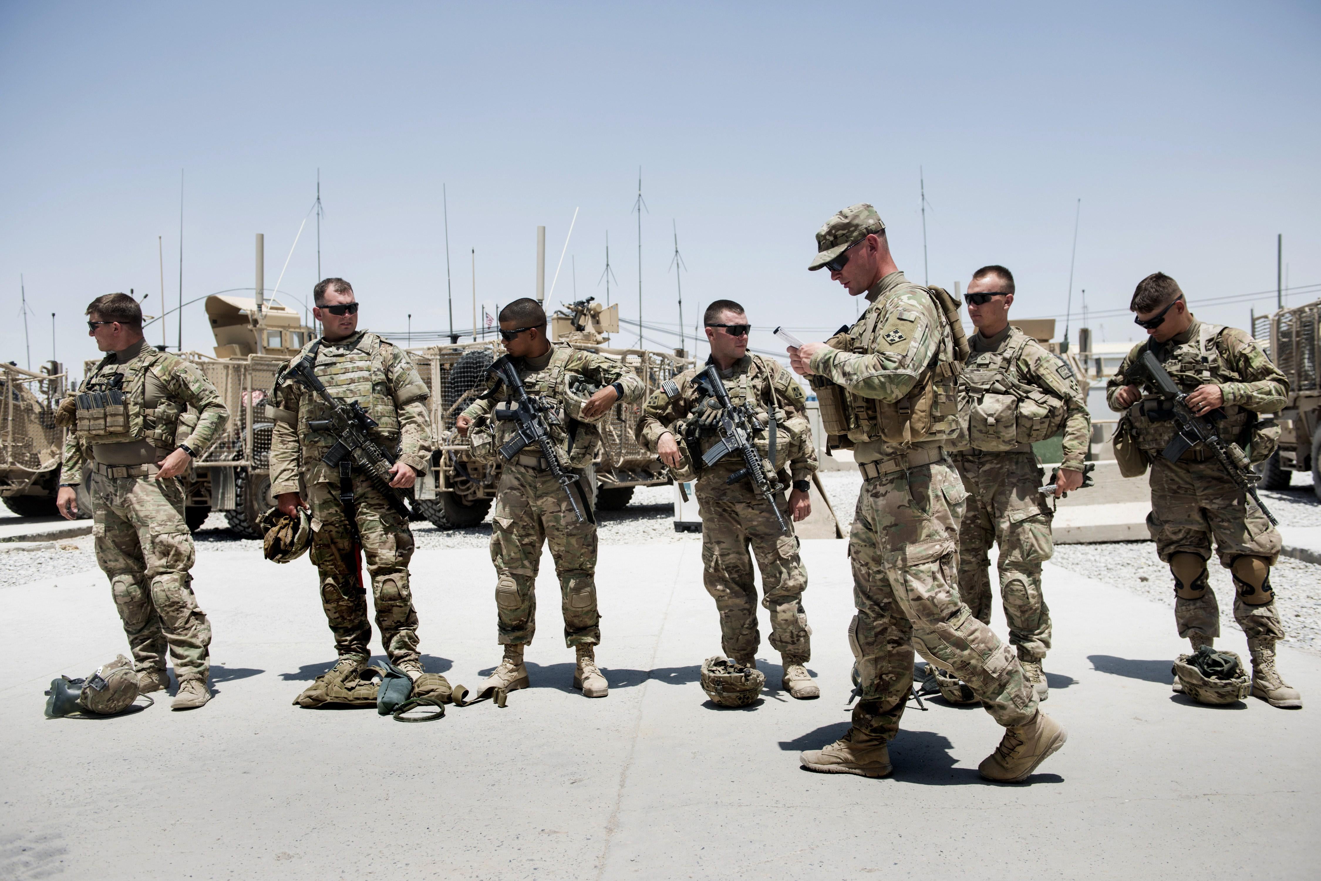 Members of the U.S. Army's 4th Infantry Division prepare for patrol at Kandahar Airfield, Afghanistan, in June 2014.