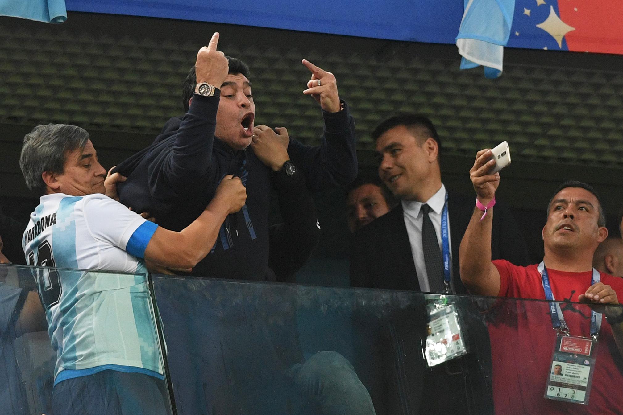TOPSHOT - Retired Argentina player Diego Maradona (C) gestures during the Russia 2018 World Cup Group D football match between Nigeria and Argentina at the Saint Petersburg Stadium in Saint Petersburg on June 26, 2018. (Photo by OLGA MALTSEVA / AFP) / RESTRICTED TO EDITORIAL USE - NO MOBILE PUSH ALERTS/DOWNLOADS        (Photo credit should read OLGA MALTSEVA/AFP/Getty Images)
