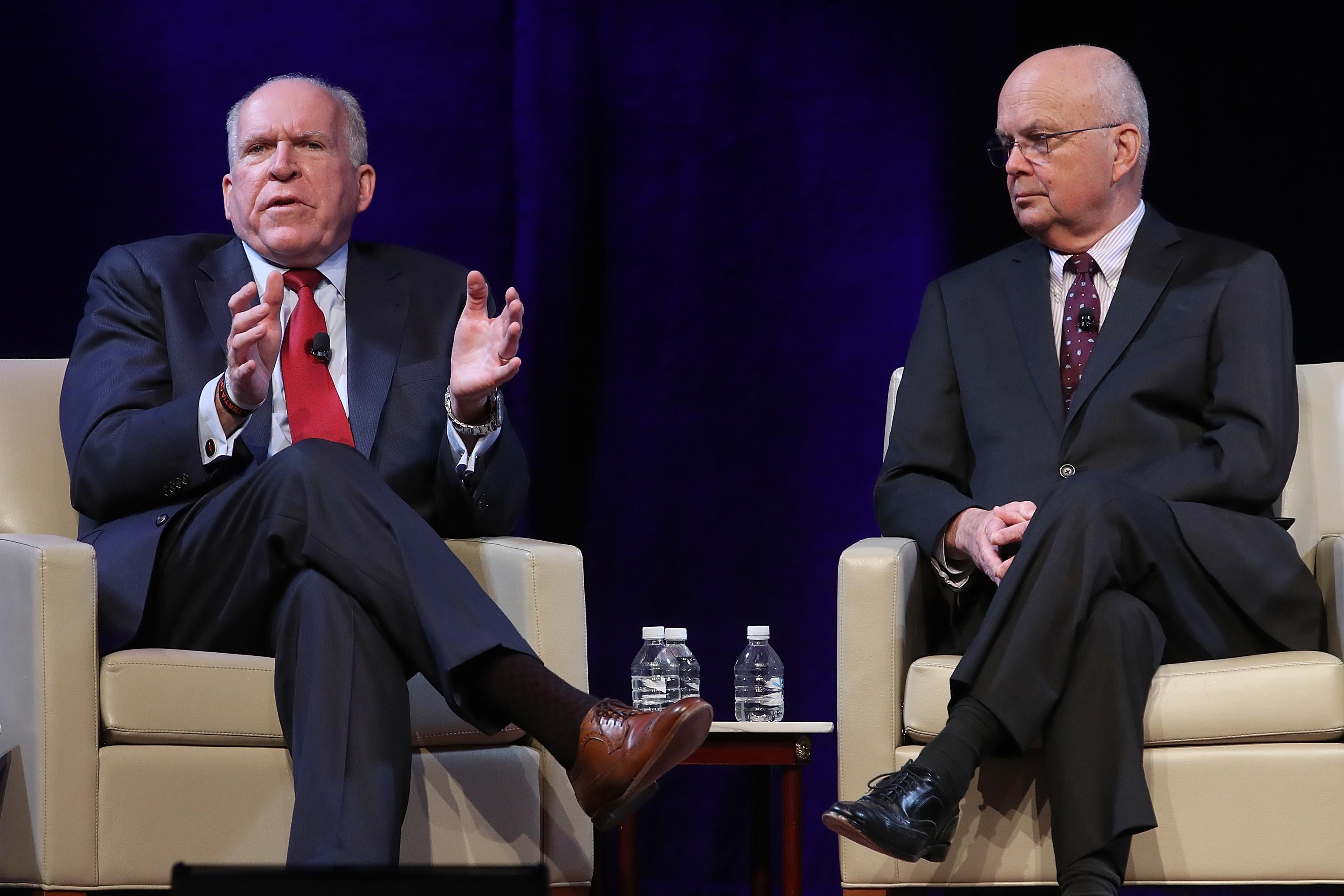 John Brennan and Michael Hayden seated in armchairs onstage.