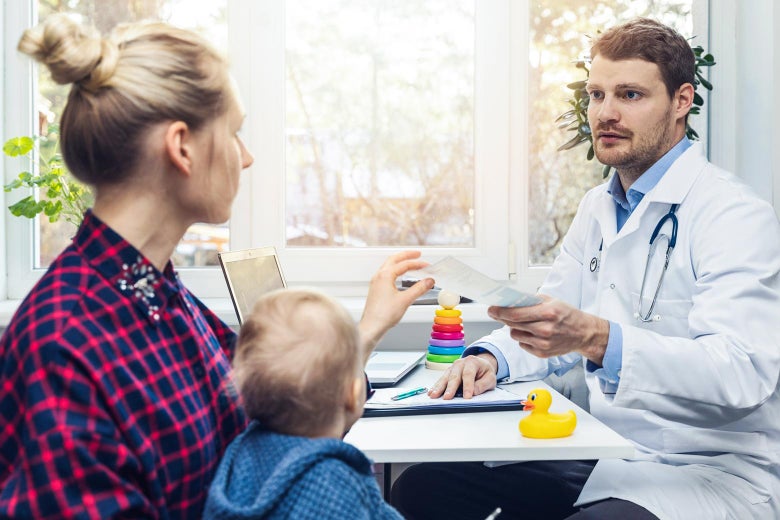 Doctor talking to mom and child. 