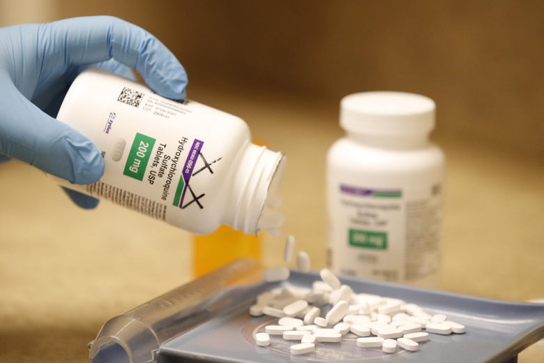 A pharmacy tech pours out pills of hydroxychloroquine at Rock Canyon Pharmacy in Provo, Utah, on May 20, 2020.