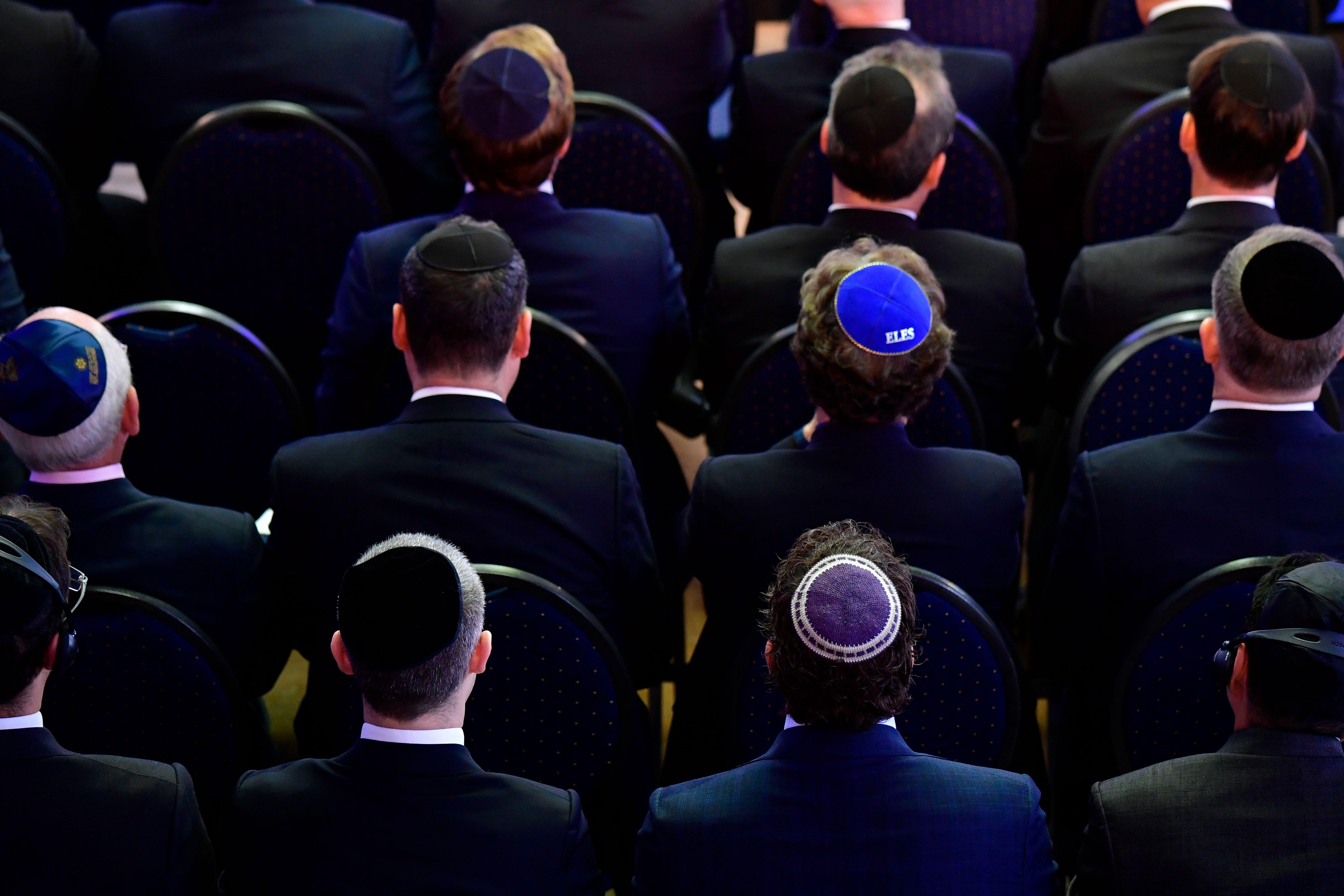 Men wearing kippah skullcaps attend an ordination ceremony at the Bet Zion synagogue in Berlin on October 8, 2018. 