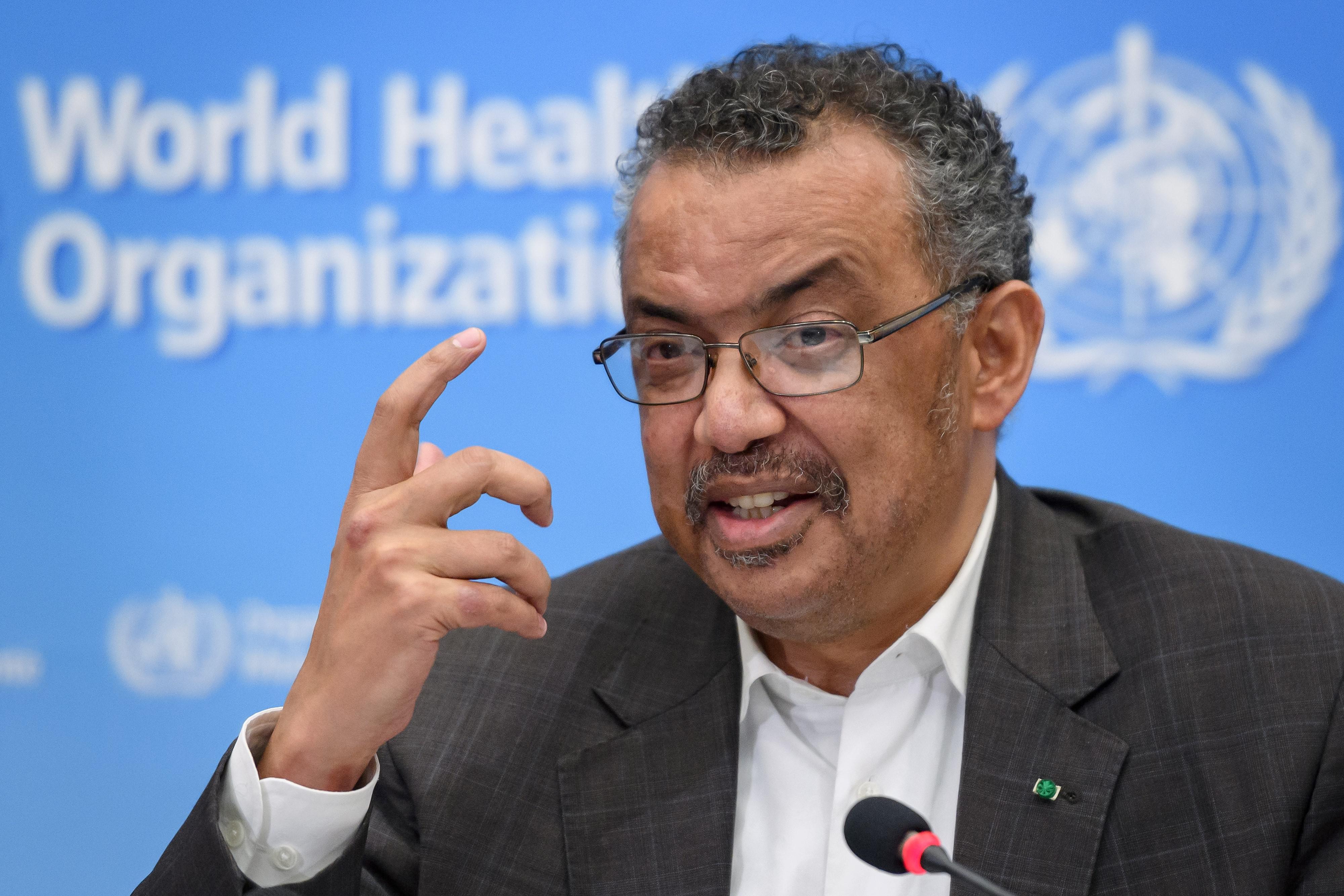 Tedros speaks at a mic at a World Health Organization press conference.