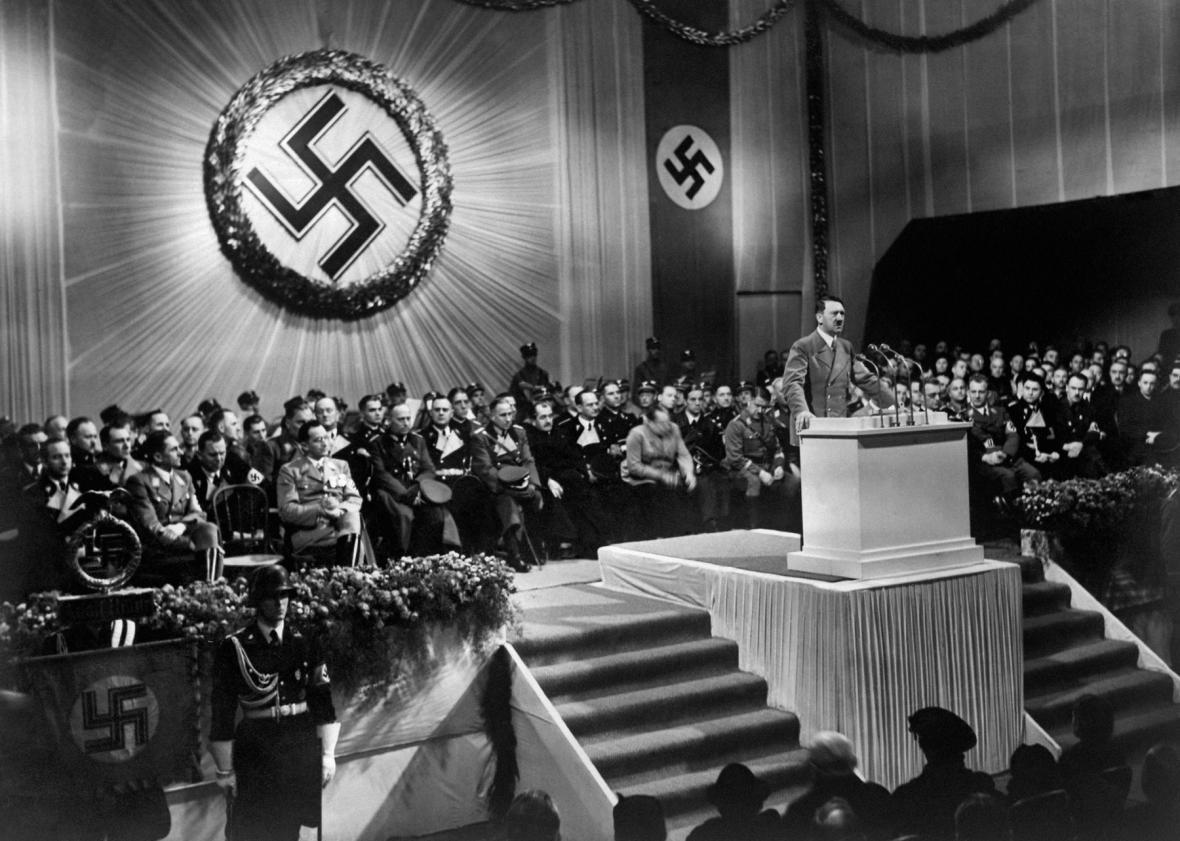 ARP2347398A picture dated 1939 shows German nazi Chancellor and dictator Adolf Hitler giving a speech during a meeting with nazi high rank officials seated under a large swastika. 