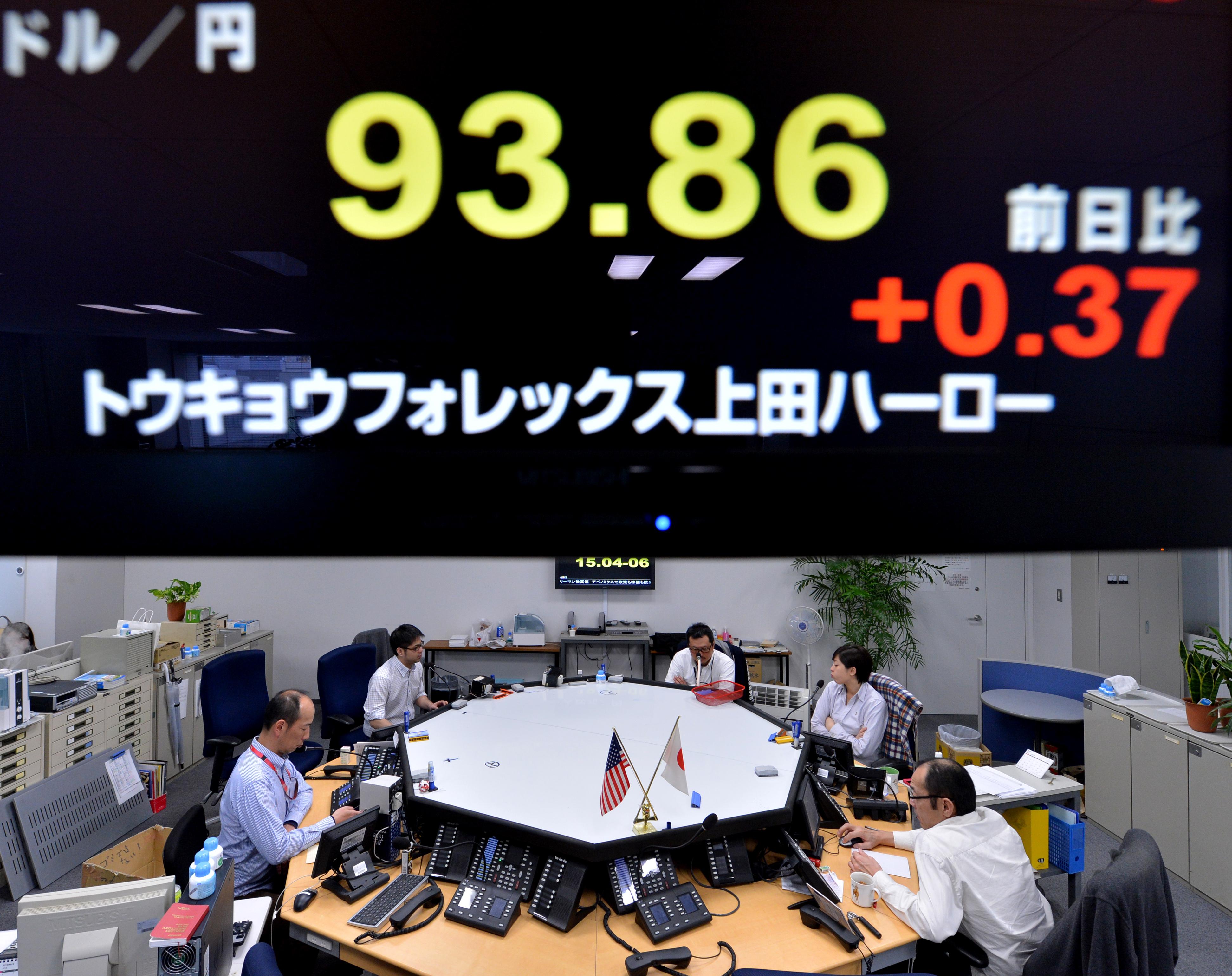 An electronic board flashes the numbers of the foreign exchange rate of the yen against $1 U.S. (top) at a foreign exchange brokerage in Tokyo on Feb. 6, 2013.