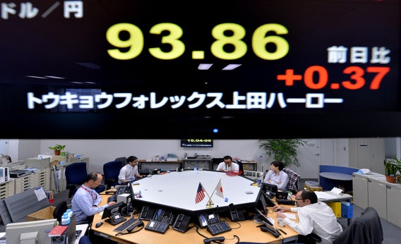 An electronic board flashes the numbers of the foreign exchange rate of the yen against $1 U.S. (top) at a foreign exchange brokerage in Tokyo on Feb. 6, 2013.