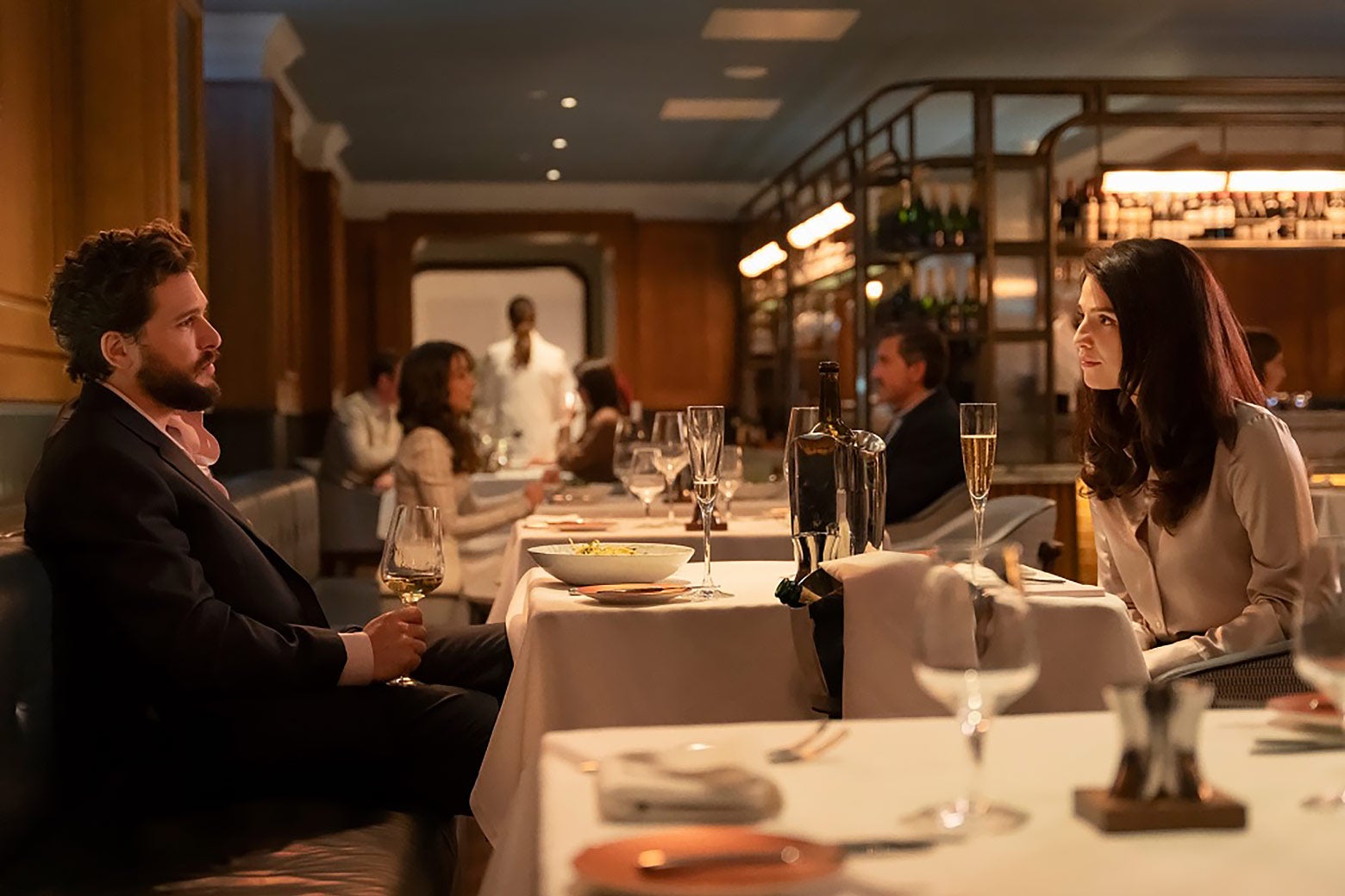 Two people on a date in a fancy restaurant.