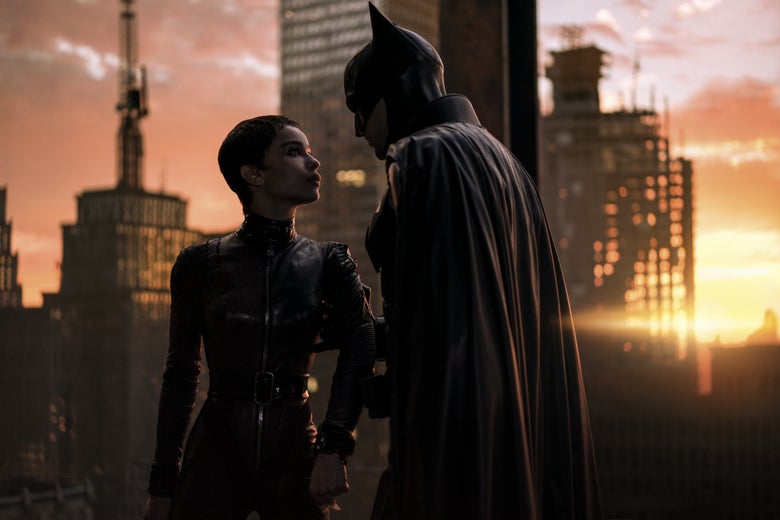 They look into each other’s eyes, both clad in black leather, as a sun perches on the Gotham horizon.