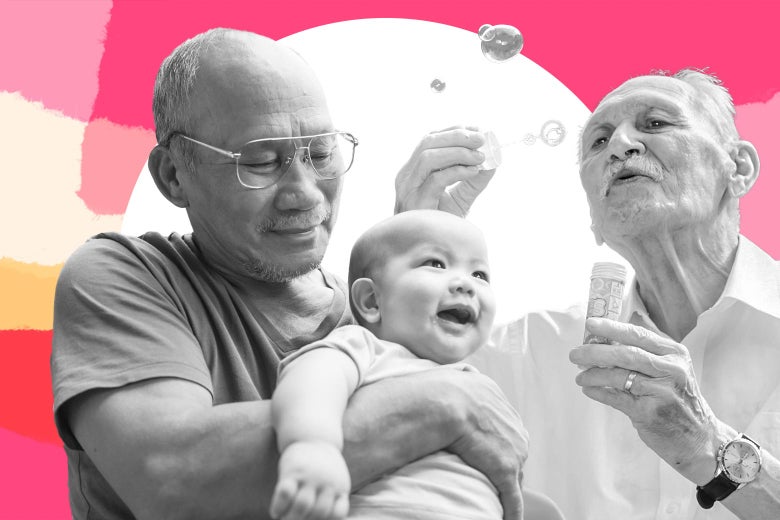 A couple of gay grandfathers plays with their grandchild. One is blowing bubbles.