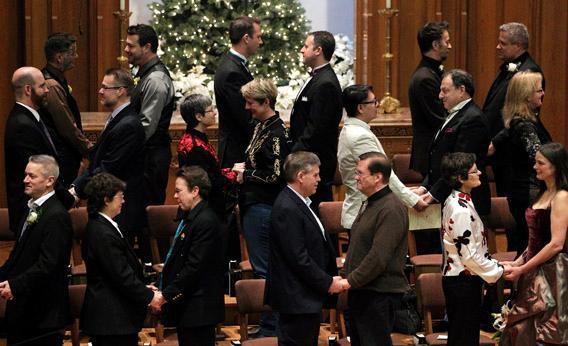 Same sex couples take their vows during a group wedding at the First Baptist Church in Seattle, Washington December 9, 2012.
