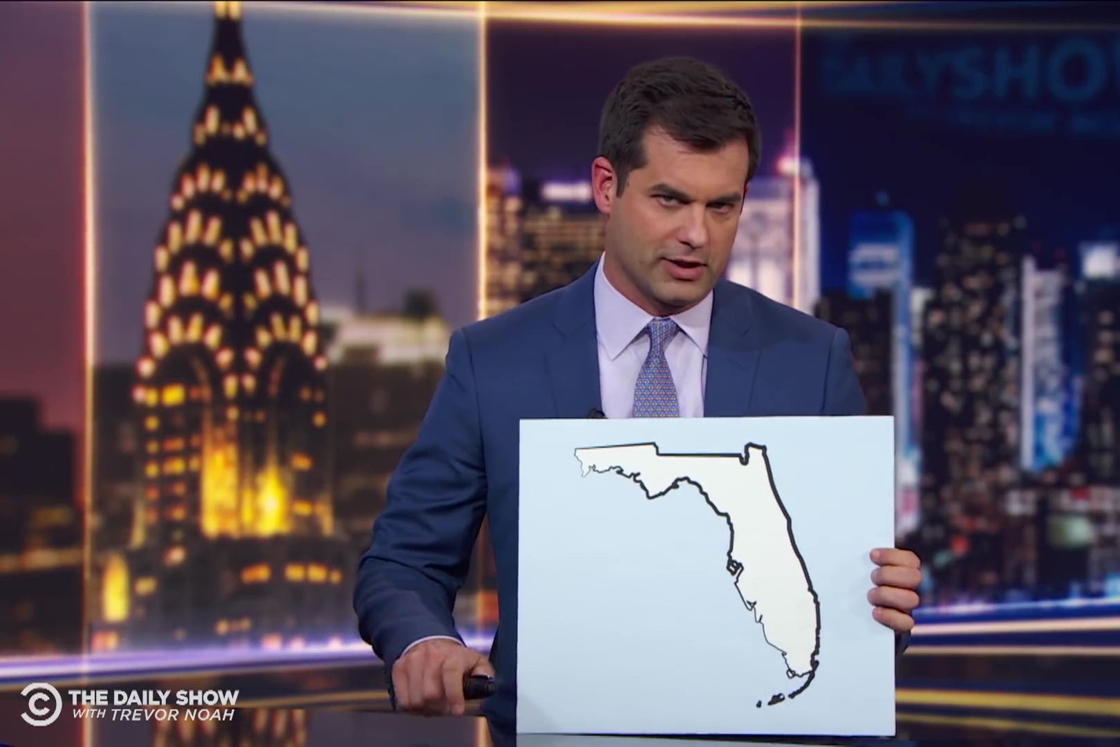 Michael Kosta holds a map of Florida.