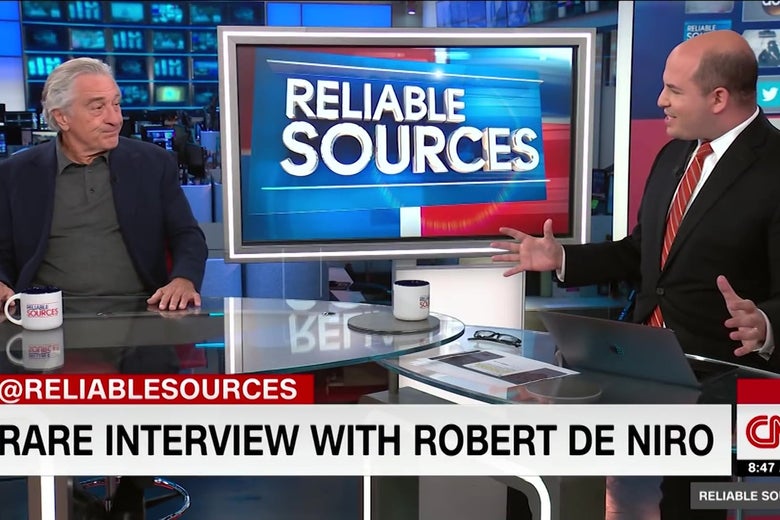 Robert De Niro makes a skeptical face as Brian Stelter asks him a question on CNN.