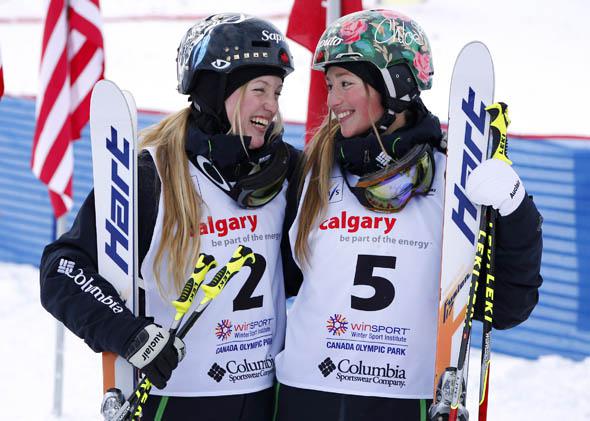 First place finisher Justine Dufour-Lapointe (L) and sister Chloe Dufour-Lapointe, third place,  smile at each other during the women's moguls finals at the FIS Freestyle Ski World Cup January 4, 2014 in Calgary, Alberta, Canada.