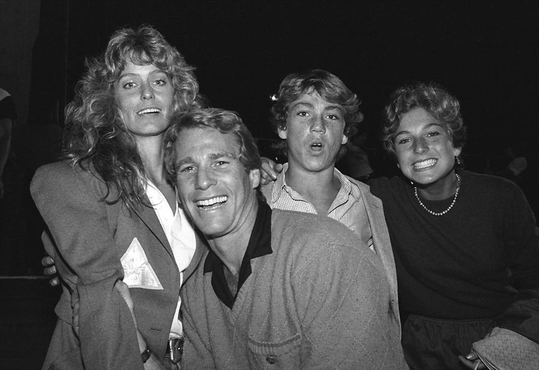 I was hanging out backstage at a Rolling Stones concert when I s,I was hanging out backstage at a Rolling Stones concert when I spotted Farrah Fawcett with Ryan O' Neal. The rumor going around, at that time, was that they were dating. Farrah, Ryan and his kids, Tatum and Griffin were on their way to their seats in the VIP section, just off the side of the stage. I approached Ryan and asked for the photo. He totally blew me off and just kept walking past me. Suddenly he turned around and said to me "No one ever asks me if they can take my photo. Since you were kind enough to ask, go for it, but just one photo," Ryan said. I sold this photo (his kids Tatum and Griffin are also in the shot) over and over again. It made about $5,000 - a fortune for a B/W photo back then. 