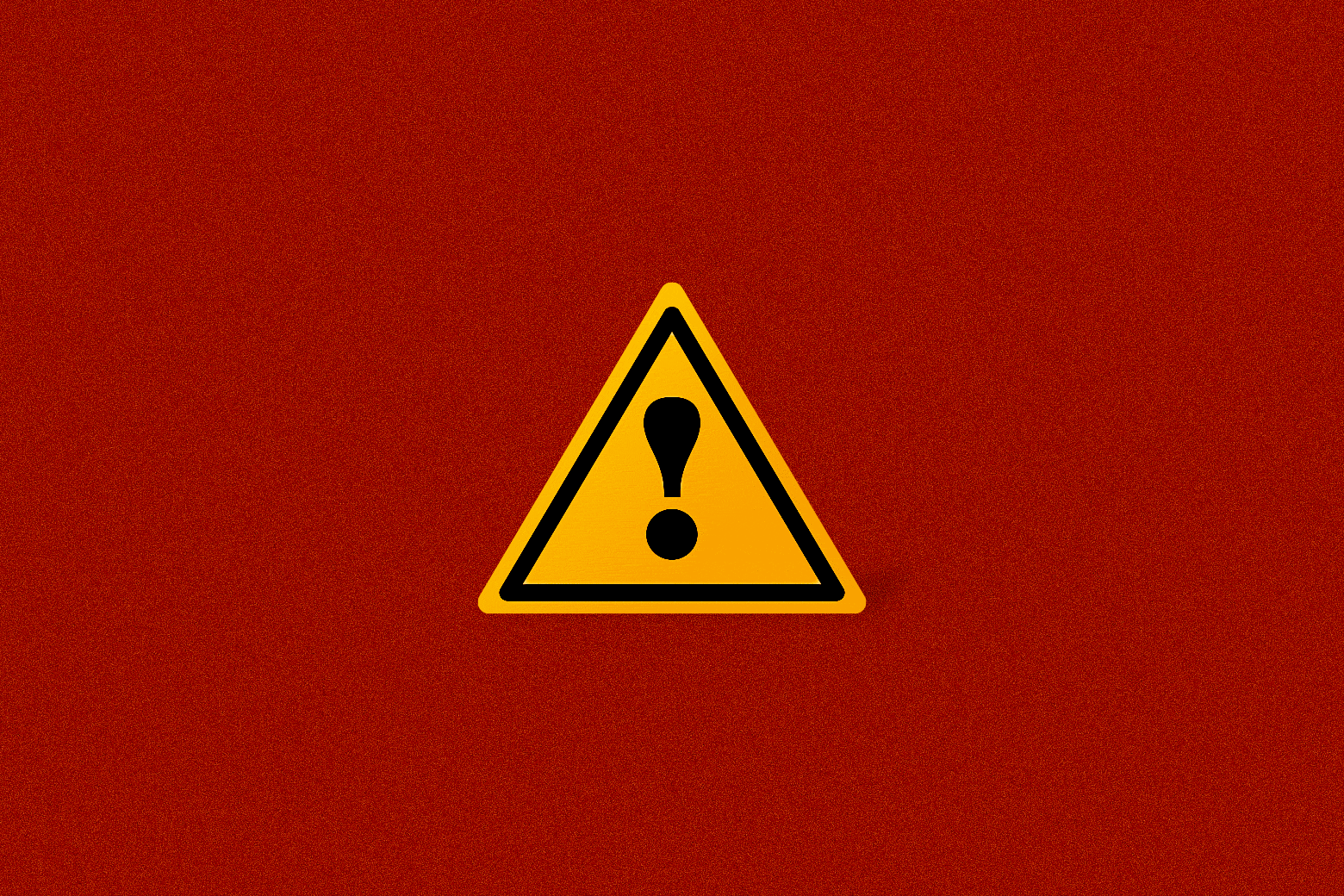 A blinking caution sign against a fuzzy red background
