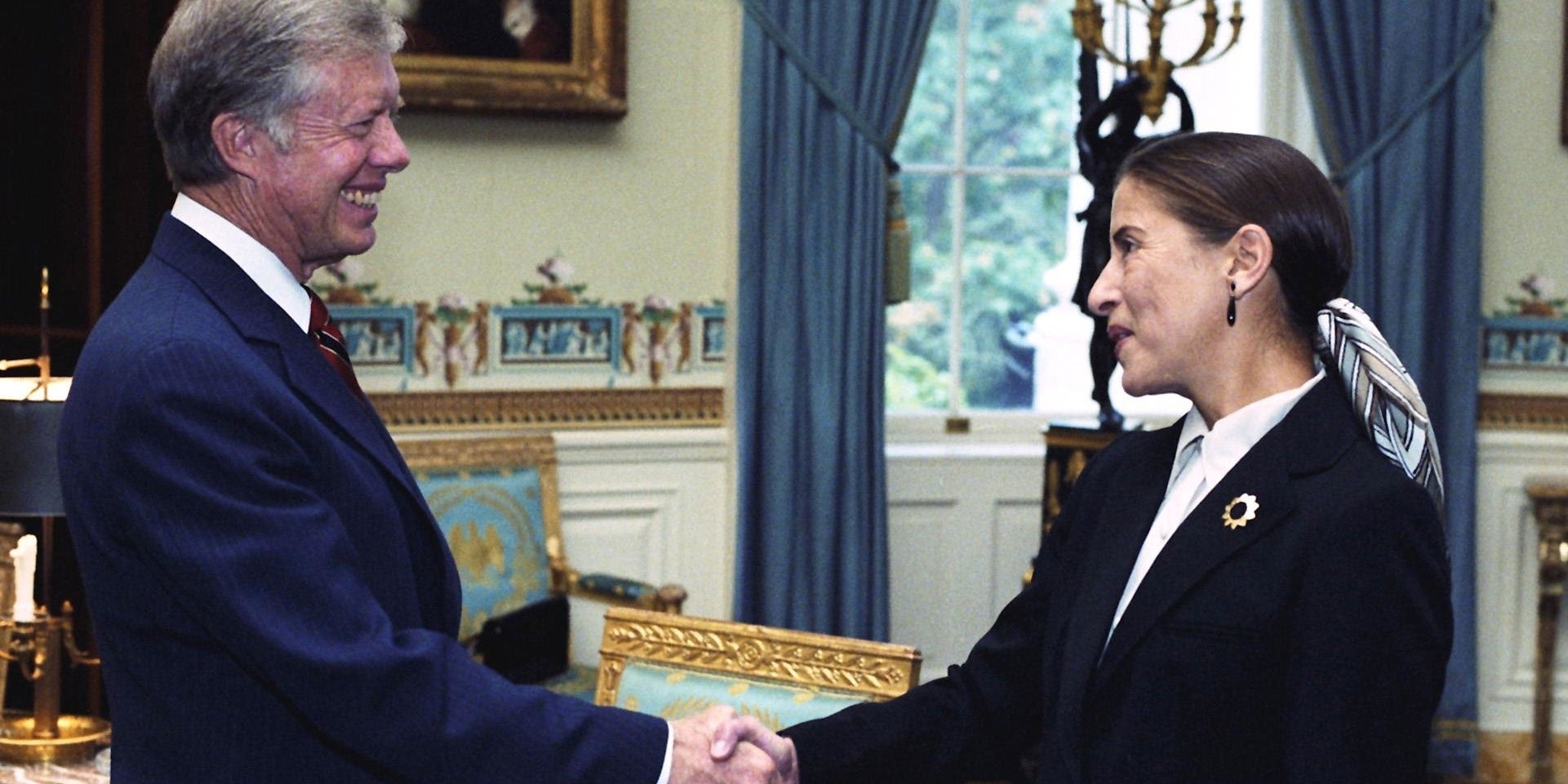 Jimmy Carter shakes Ruth Bader Ginsburg’s hand in an archival photo.