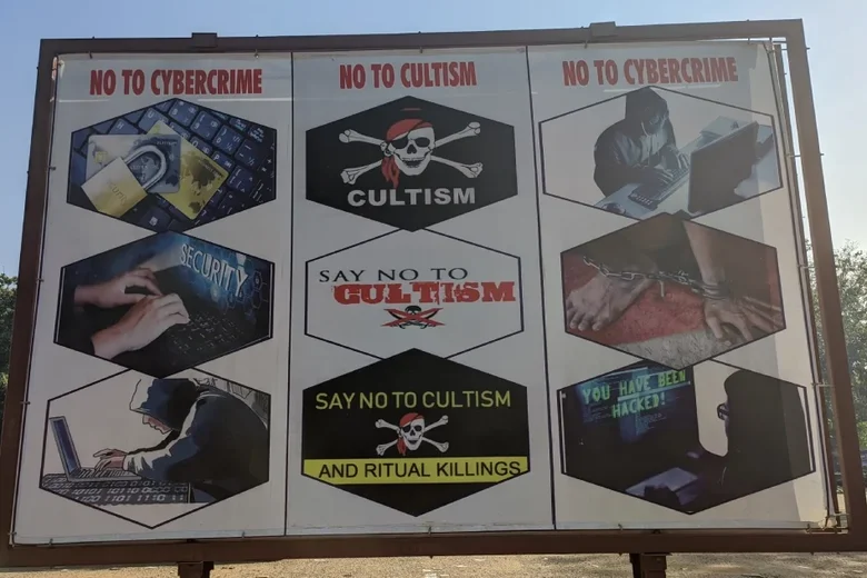 A billboard says "No to Cybercrime, No to Cultism, No to Cybercrime."